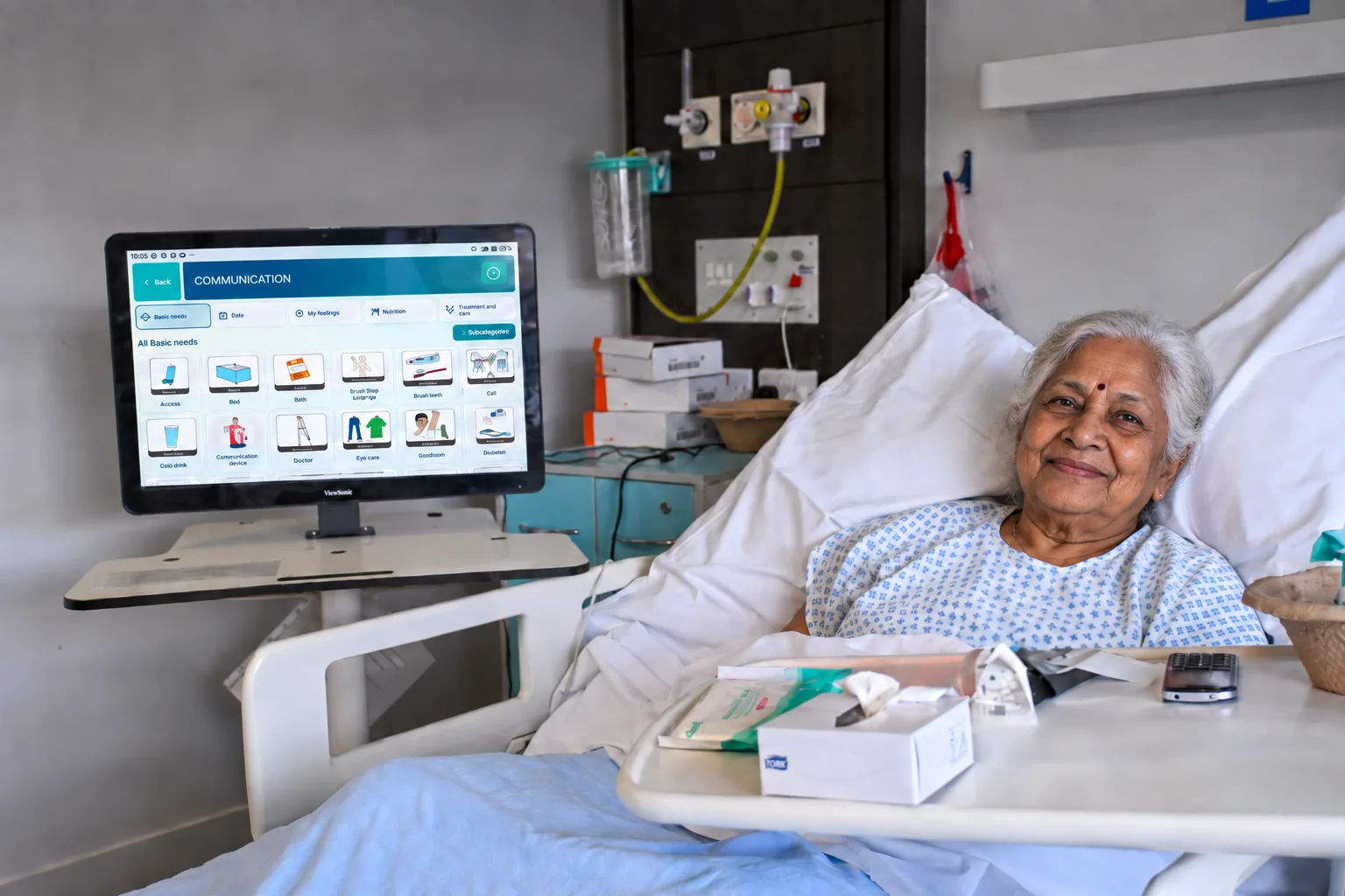 A hospital patient using the TESS communication screen from their bedside