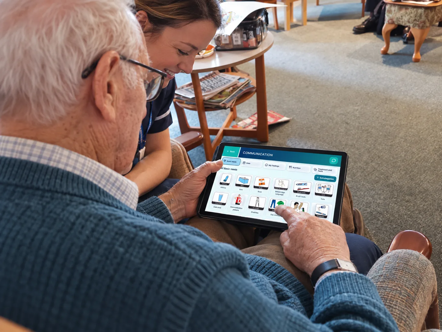 An older person and care worker using TESS together in a care home